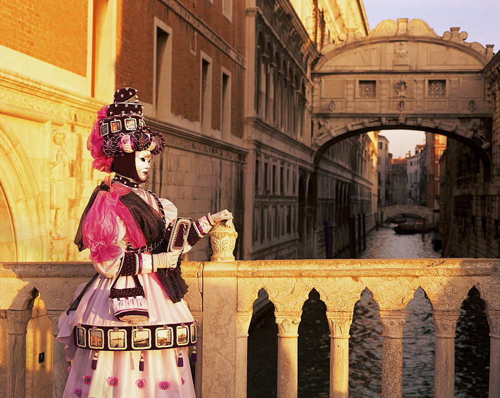 Carnival costume and the Bridge of Sighs, Venice, Veneto, Italy, Europe