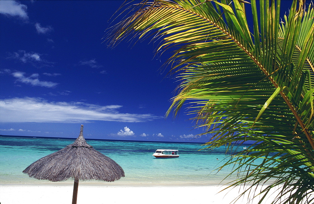 Moored boat off beach at Le Trou Aux Biches, Mauritius, Africa