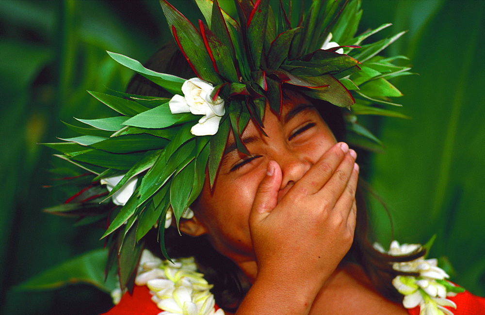 Portrait of laughing girl with her hand over her mouth, Tahiti, French Polynesia, Pacific Islands