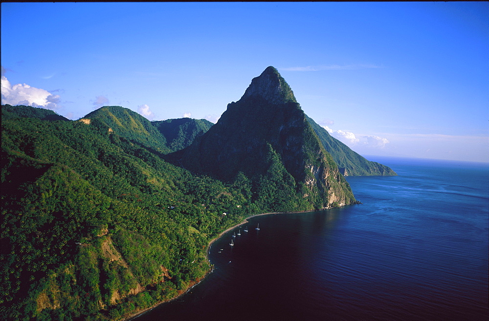 Aerial view over boats moored off a beach below the Petit Piton, St Lucia