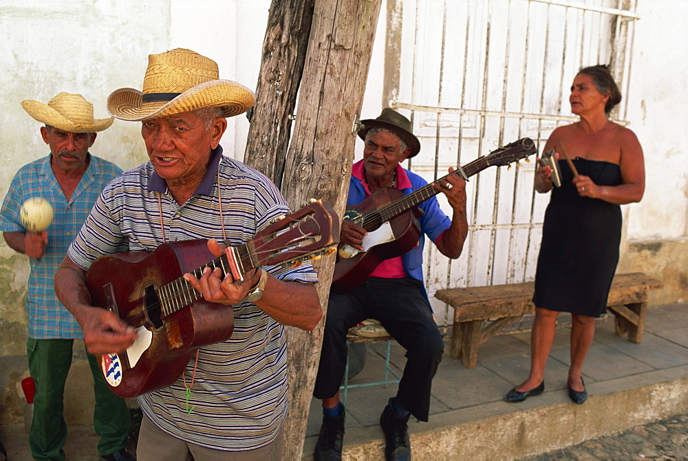 Group of three elderly men and a woman playing music, Trinidad, Cuba, West Indies, Central America