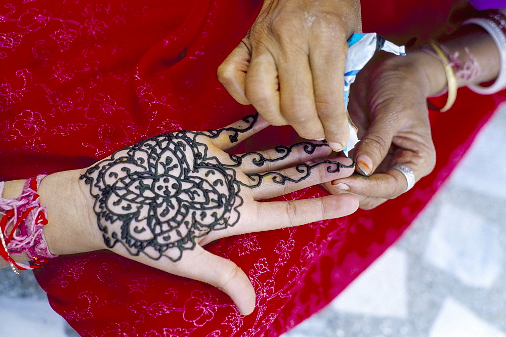 Henna designs being applied to a woman's hand, Rajasthan state, India, Asia