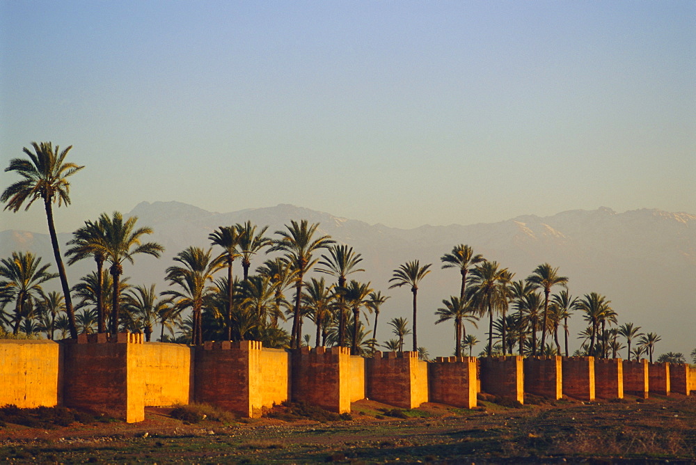 City walls and Atlas Mountains in the distance, Marrakesh, Morocco, North Africa