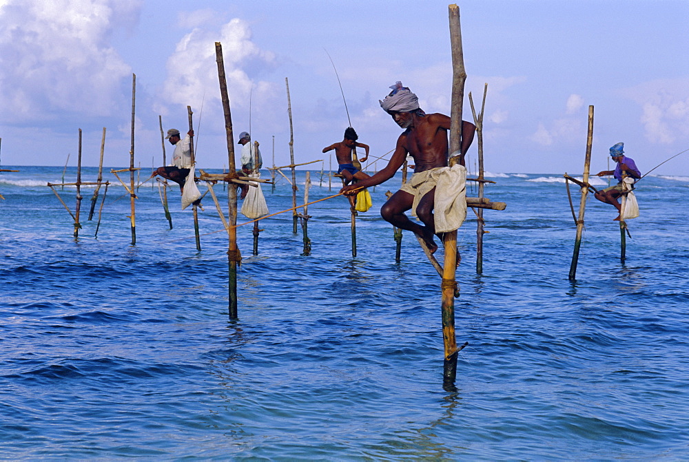 Stilt fishermen at Welligama, south coast, Sri Lanka, Indian Ocean, Asia