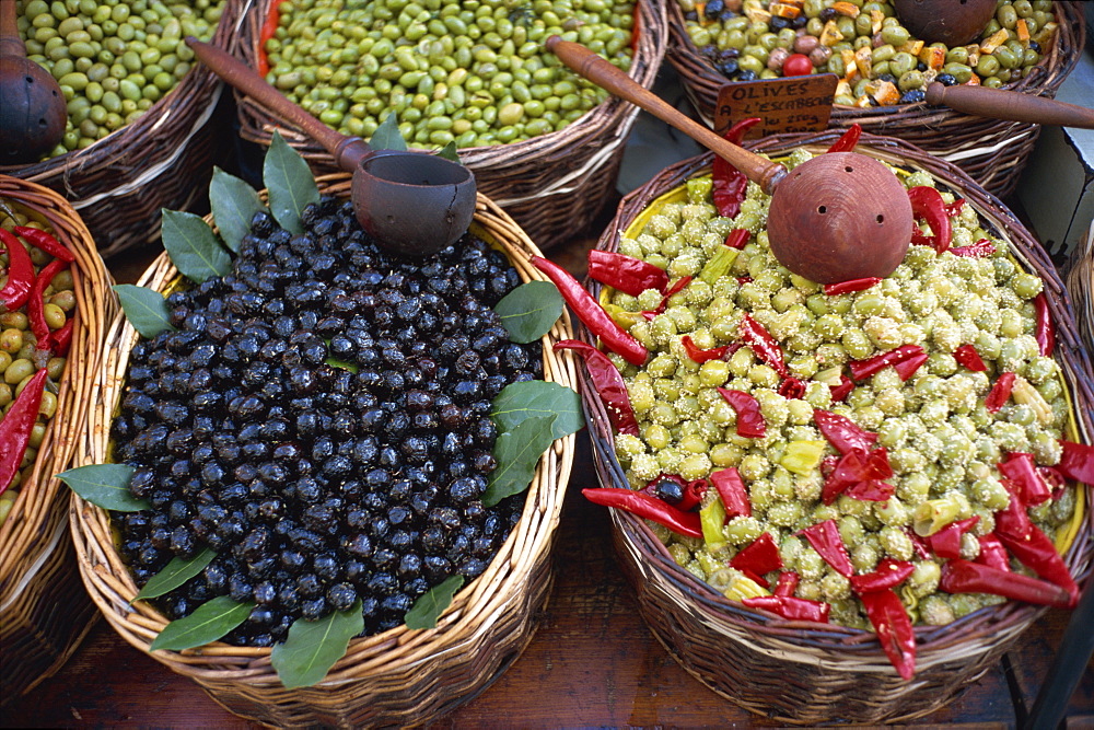 High angle view of baskets of black and green olives on a stall in the market, Provence, France, Europe