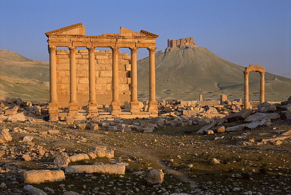 Funerary temple at archaeological site and Arab castle beyond, Palmyra, UNESCO World Heritage Site, Syria, Middle East