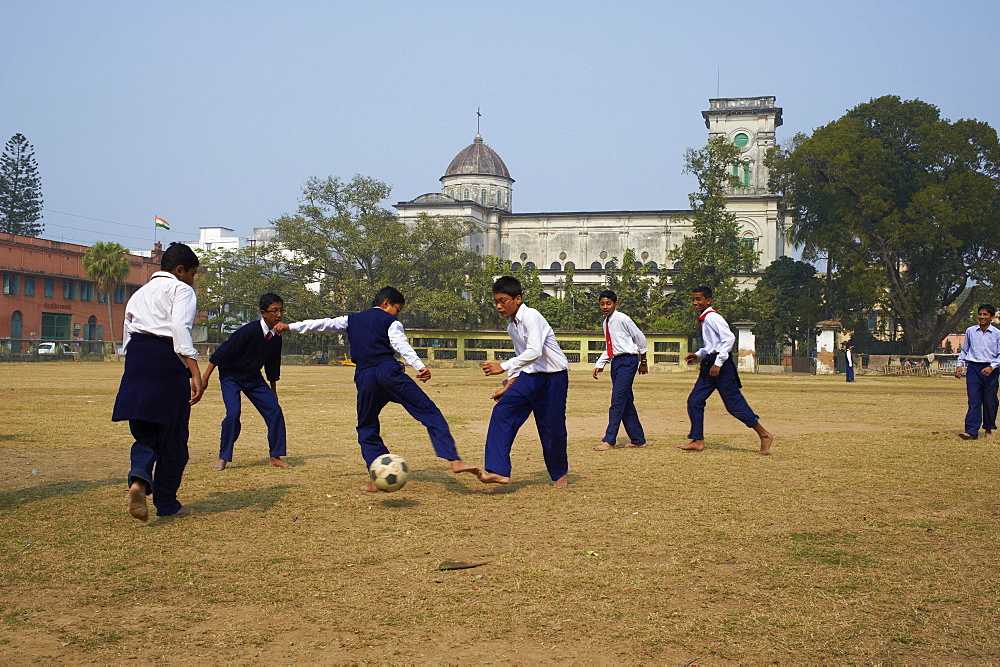 Students playing football, Sacred Heart church, Chandernagor (Chandannagar), a former French colony, West Bengal, India, Asia