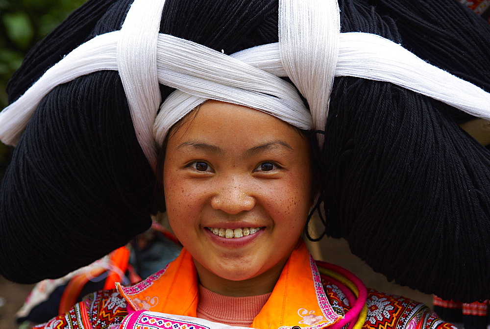 Long Horn Miao girls in traditional costumes celebrating Flower Dance Festival, Longjia village, Guizhou Province, China, Asia