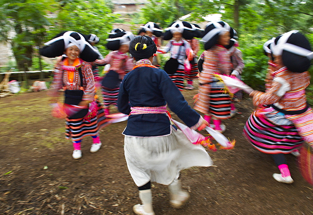 Long Horn Miao girls in traditional costumes celebrating Flower Dance Festival, Longjia village, Guizhou Province, China, Asia