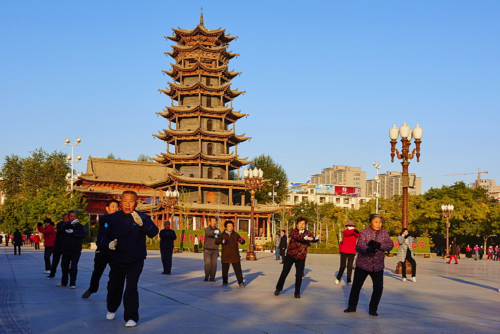 Morning exercises in front of the wooden pagoda on the main square, Zhangye, Gansu Province, China, Asia