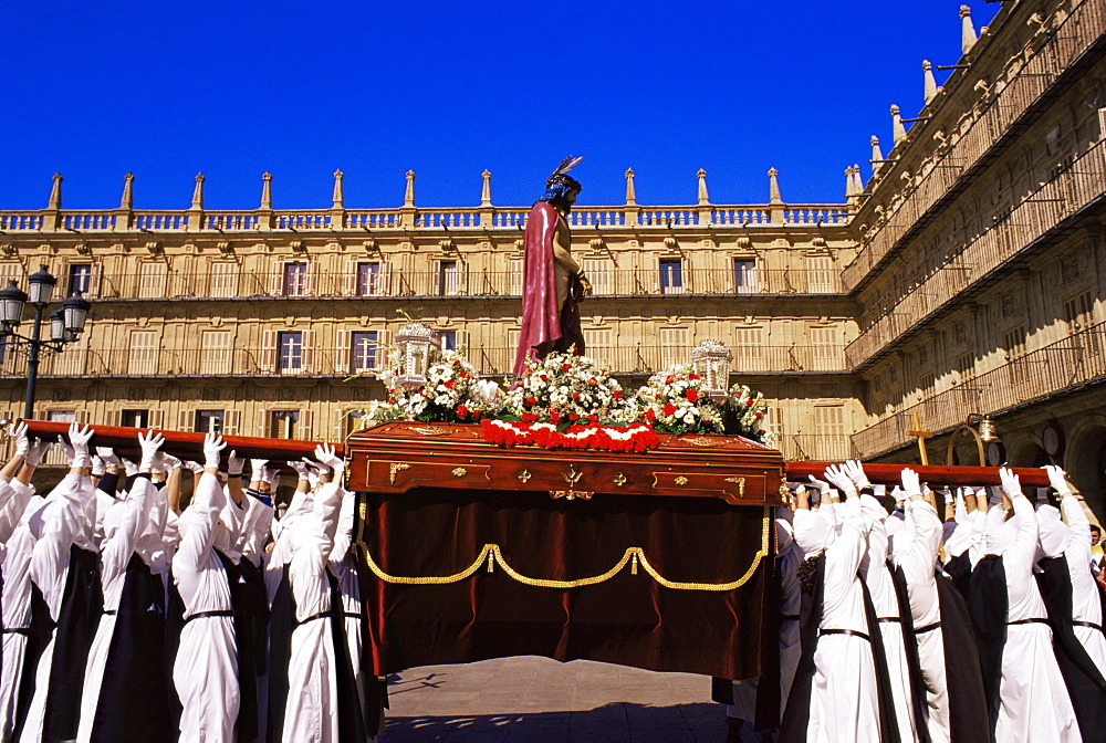 Penitents lifting the Jesus Christ carriage during Semana Santa (Holy Week) procession, Salamanca, Castilla y Leon (Old Castile), Spain, Europe