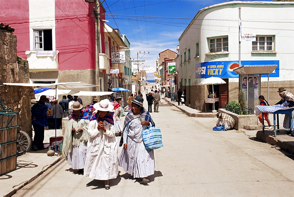 Women walking down street, Copacabana, LakeTiticaca, Bolivia, South America