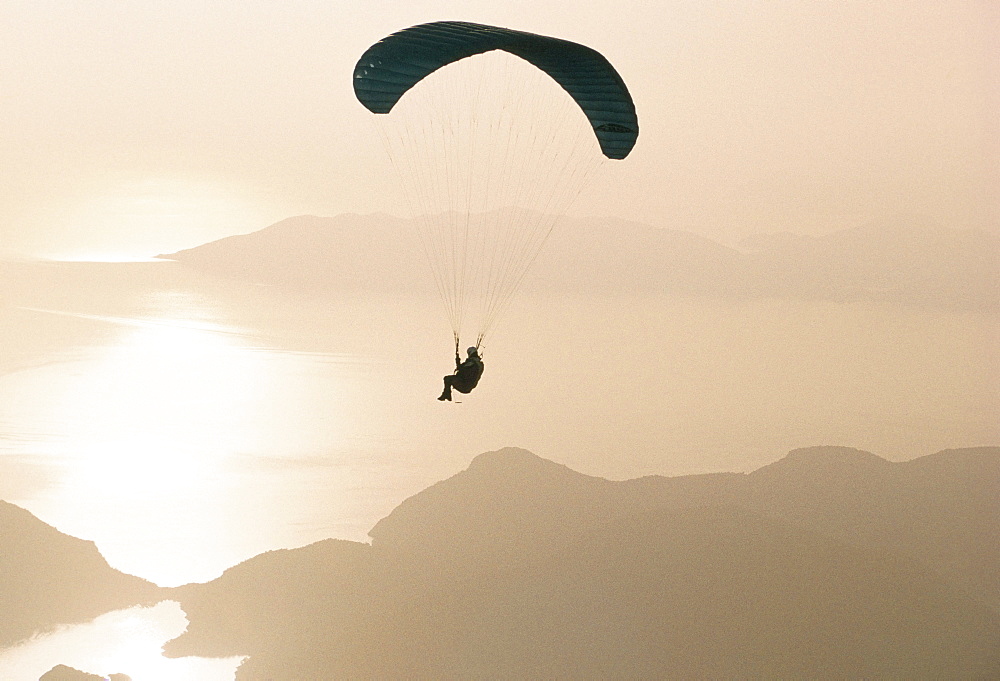 Man paragliding over the Mediterranean coast, Fethiye, Turkey, Asia