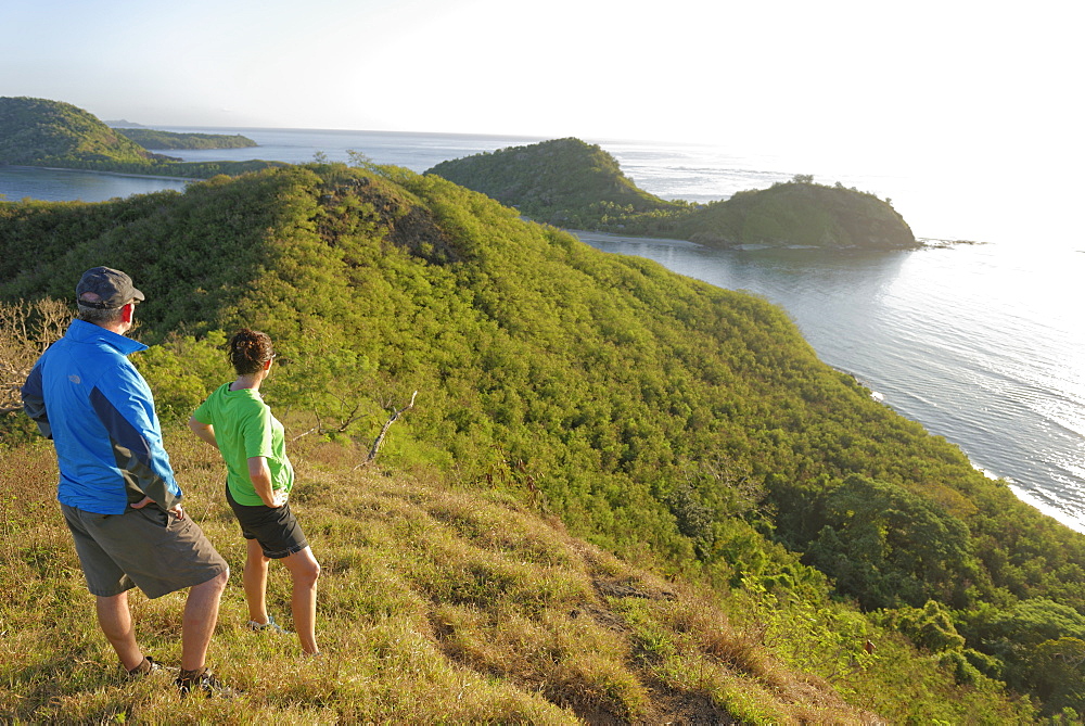 Couple viewing island beauty from the top, Drawaqa Island, Yasawa island group, Fiji, South Pacific islands, Pacific