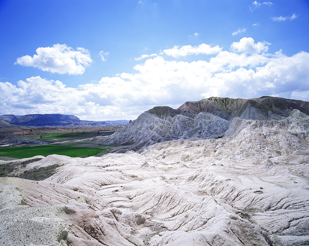 Rocks and green fields in distance, near Avanos, Cappadocia, Anatolia, Turkey, Eurasia