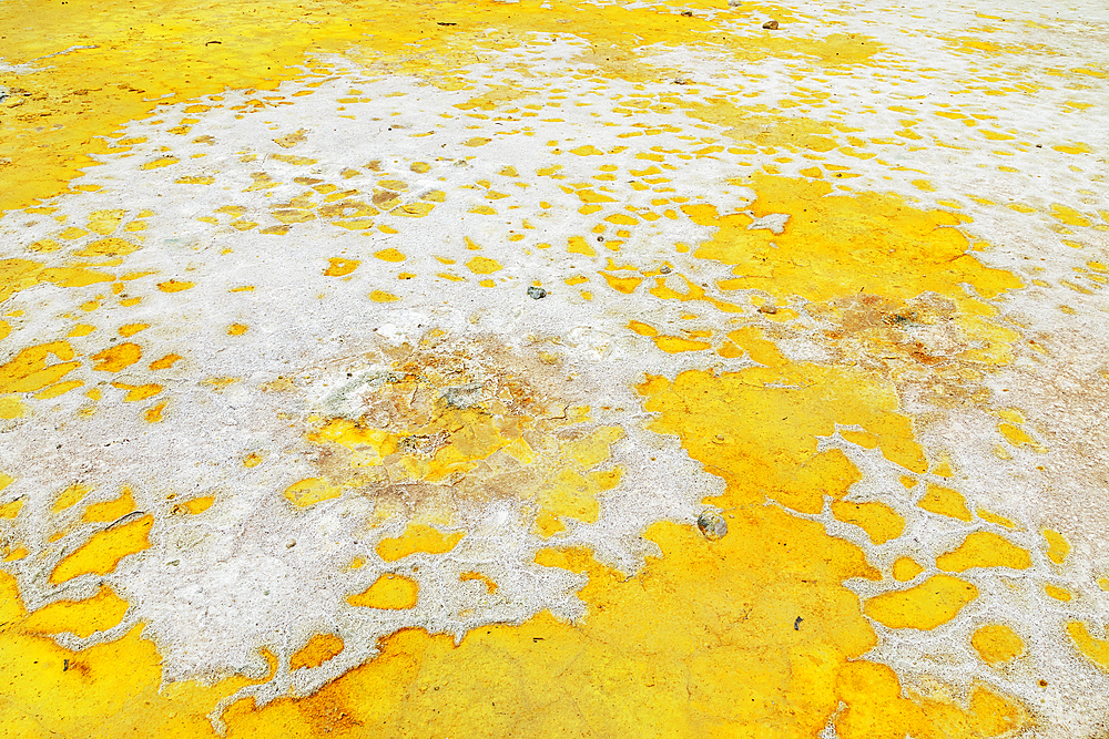 Splashes of sulphur colouring Stefanos crater ground, Nisyros Island, Dodecanese Islands, Greece