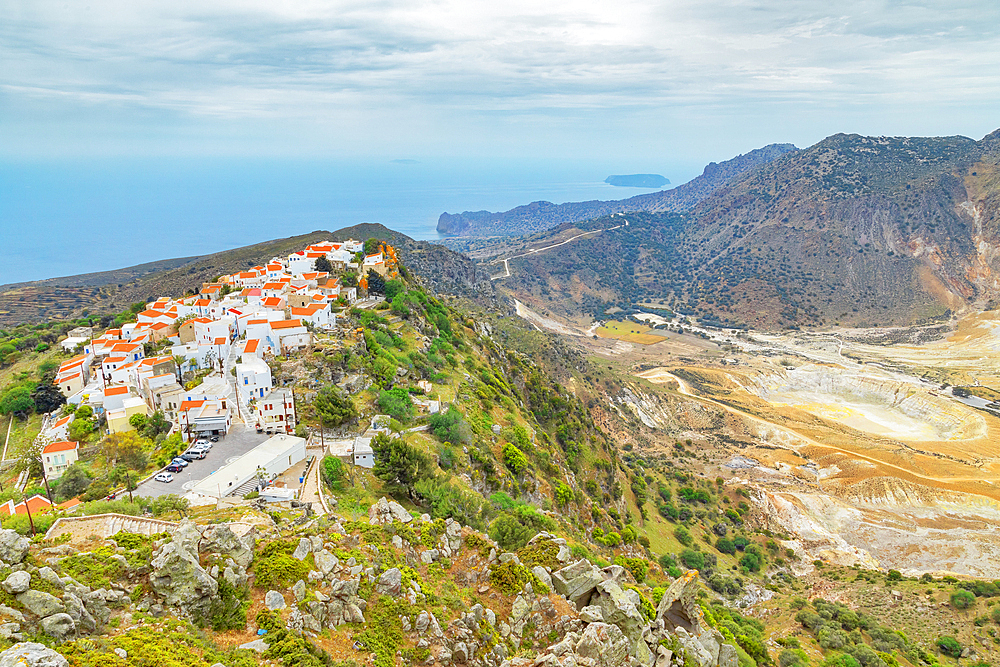 Nikia village and Nisyros volcano in the distance, high anlgle view, Nisyros Island, Dodecanese Islands, Greek Islands, Greece, Europe