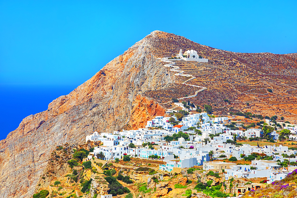 View of Chora village built on a cliff above the sea and Panagia Kimissis church, Chora, Folegandros Island, Cyclades Islands, Greece