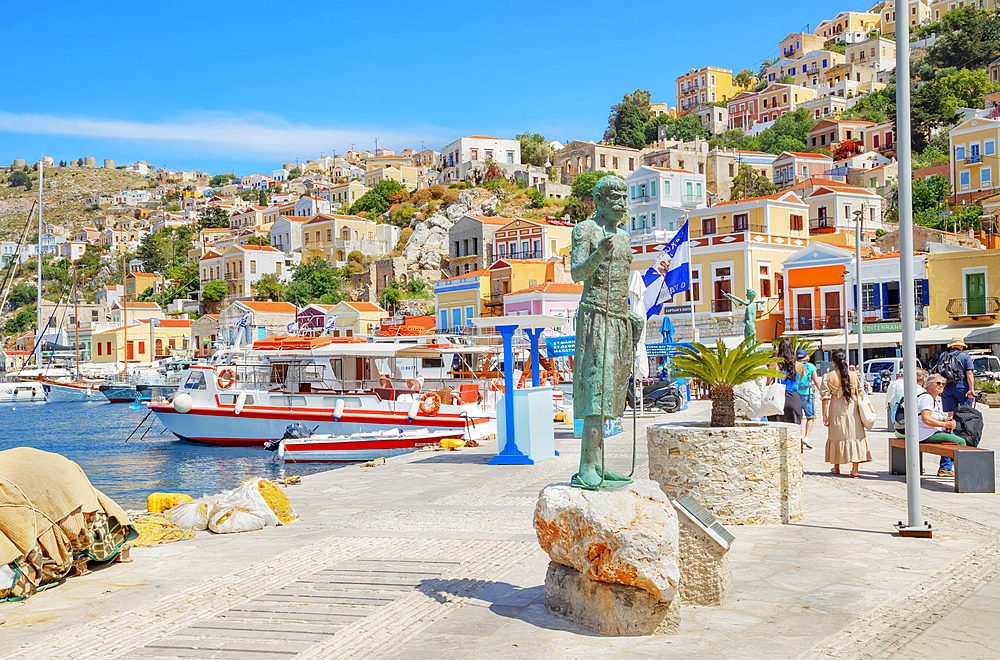 Monument to the legendary Greek sponge diver Stathis Hatzis on Gialos harbour waterfront, Symi Island, Dodecanese Islands, Greece