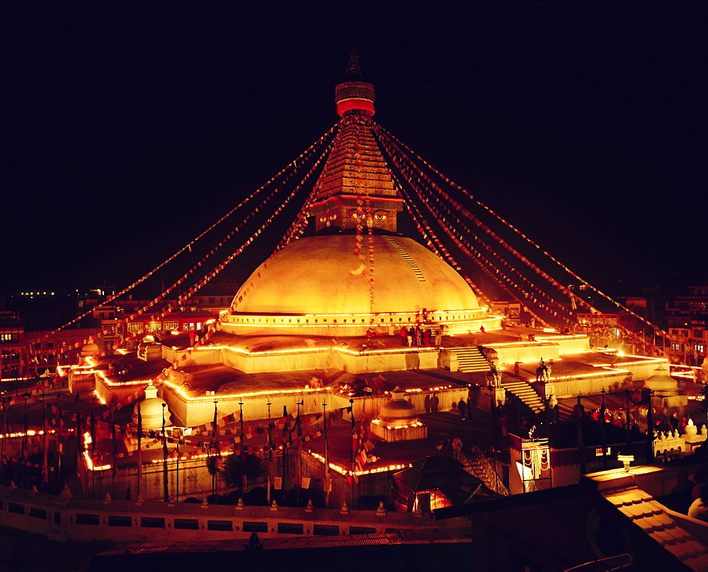 Buddhist stupa lit by candles at night, Bodnath, Kathmandu, Nepal, Asia