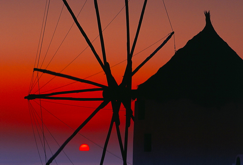 Silhouette of windmill at sunset, Oia, Santorini (Thira), Cyclades islands, Greece, Mediterranean, Europe