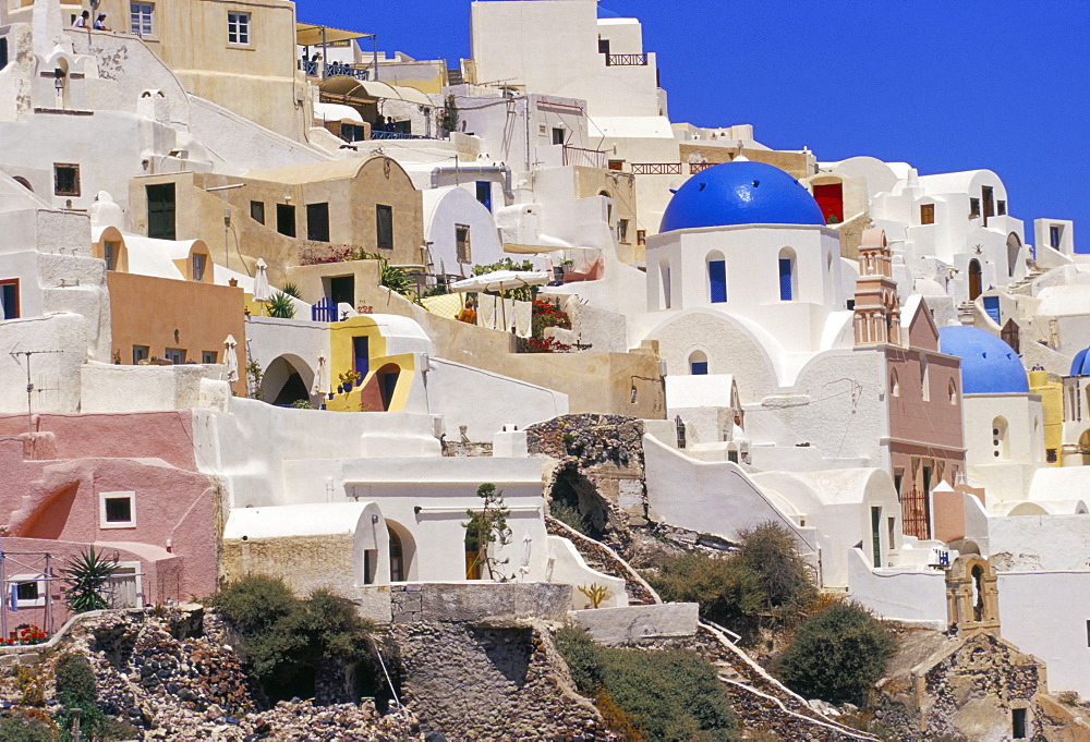 Village of Oia with blue churches and colourful dwellings, Oia, Santorini (Thira), Cyclades islands, Greece, Mediterranean, Europe