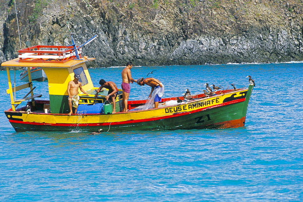 Fishermen on fishing boat, Parque Nacional de Fernando de Norohna, Fernando de Noronha, Pernambuco, Brazil, South America