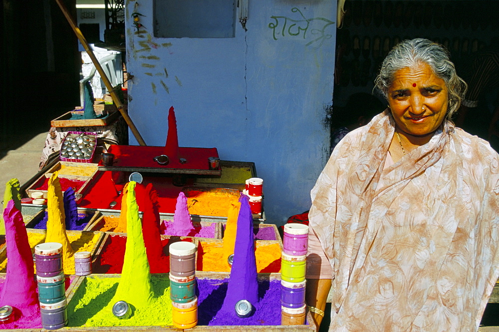 Hindu woman selling colourful powders, Pushkar, Rajasthan state, India, Asia