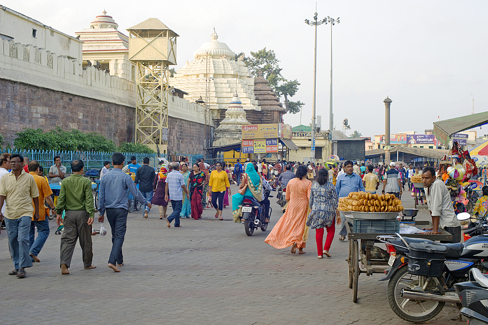 Pilgrims, devotees and locals outside the walls of the Jagannath Temple dedicated to Lord Jagannath, an embodiment of Krishna, situated in Puri,the oldest of India's four holiest Hindu religious centres, in the State of Odisha, India, Asia