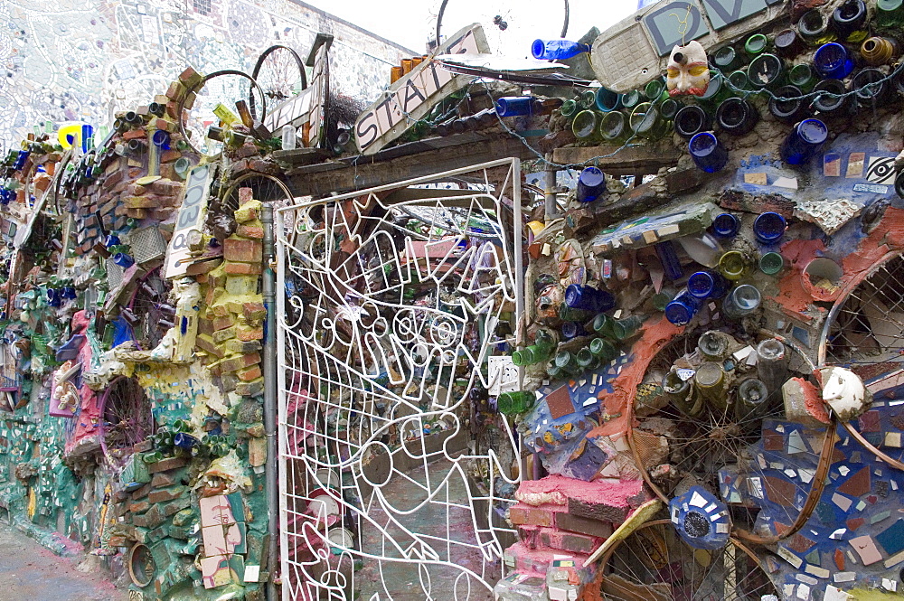 Decoration of patterns in glass, mirrors, ceramics and other fragments of objects embedded in stucco by sculptor Isaiah Zagar, South Street, Philadelphia, Pennsylvania, United States of America, North America