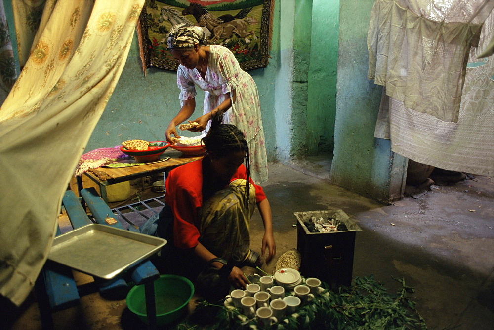 Women preparing food and drink for coffee ceremony, Abi Adi village, Tigre region, Ethiopia, Africa