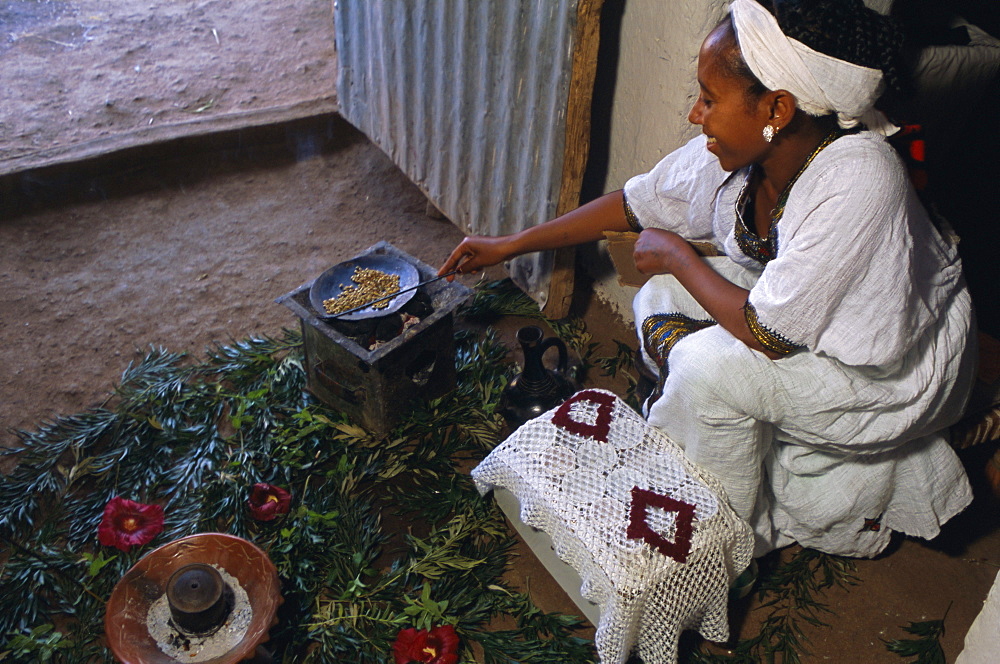 Woman roasting beans for coffee ceremony, Lalibela, Wollo region, Ethiopia, Africa