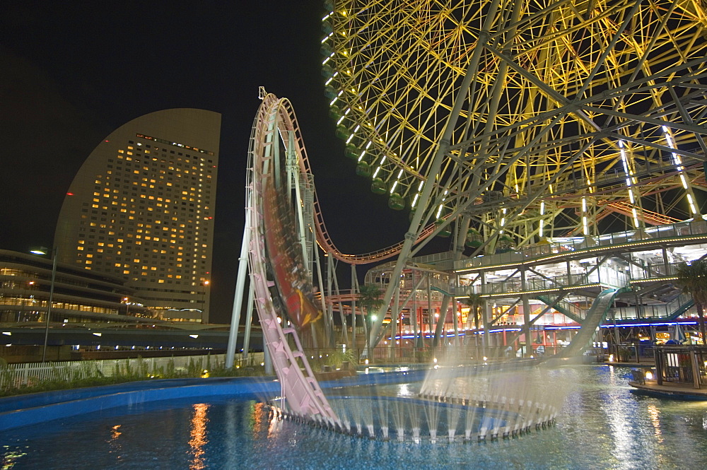 Rollercoaster and fun fair amusement park at night, Minato Mirai, Yokohama, Japan, Asia