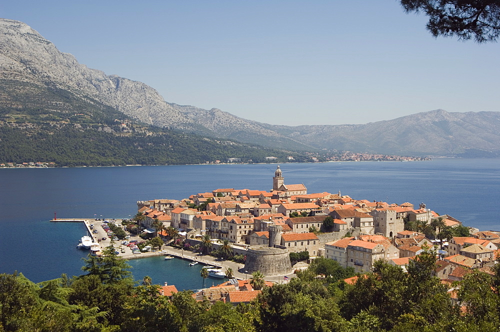 Hilltop view of red tile rooftops of medieval Old Town and Bay, Korcula Island, Dalmatia Coast, Croatia, Adriatic, Europe