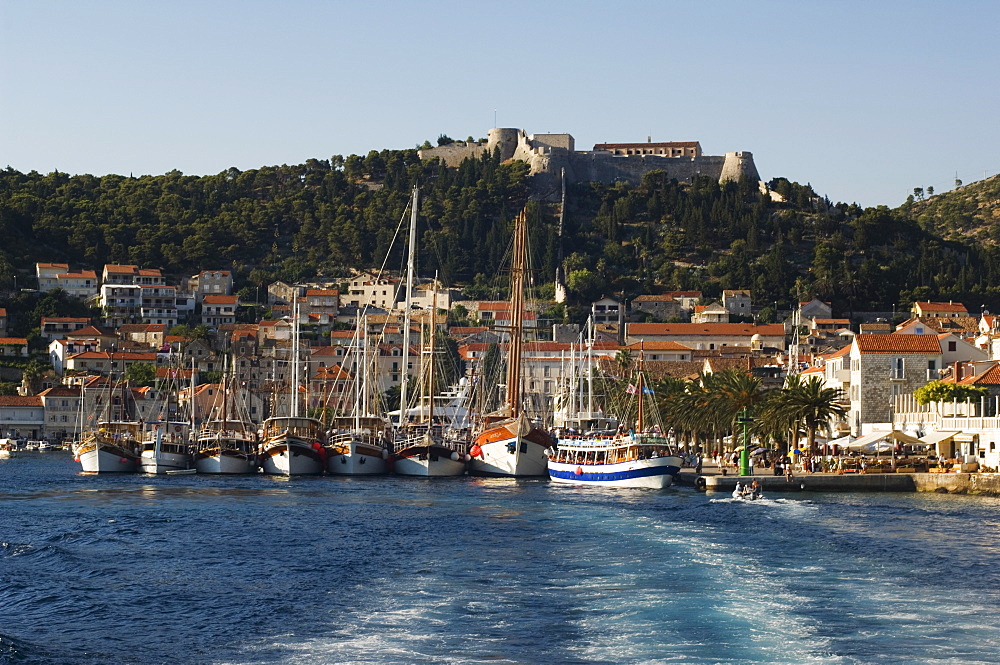 Harbour area and Venetian fortress dating from 1551 on the hill, Hvar Island, Dalmatia, Croatia, Europe