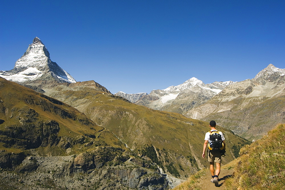 Hiker walking on trail near the Matterhorn, 4477m, Zermatt Alpine Resort, Valais, Switzerland, Europe 