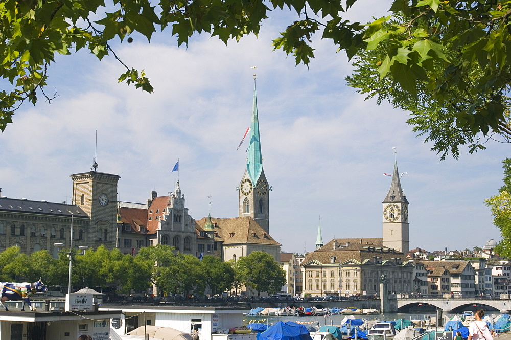 Boats on the Limmat River with St. Peter church and Fraumunster church behind, Zurich, Switzerland, Europe