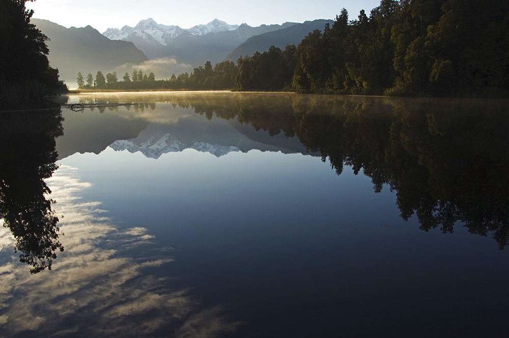 Lake Matheson in the evening reflecting a near perfect image of Mount Tasman and Aoraki (Mount Cook), 3754m, Australasia's highest mountain, South Island, New Zealand, Pacific