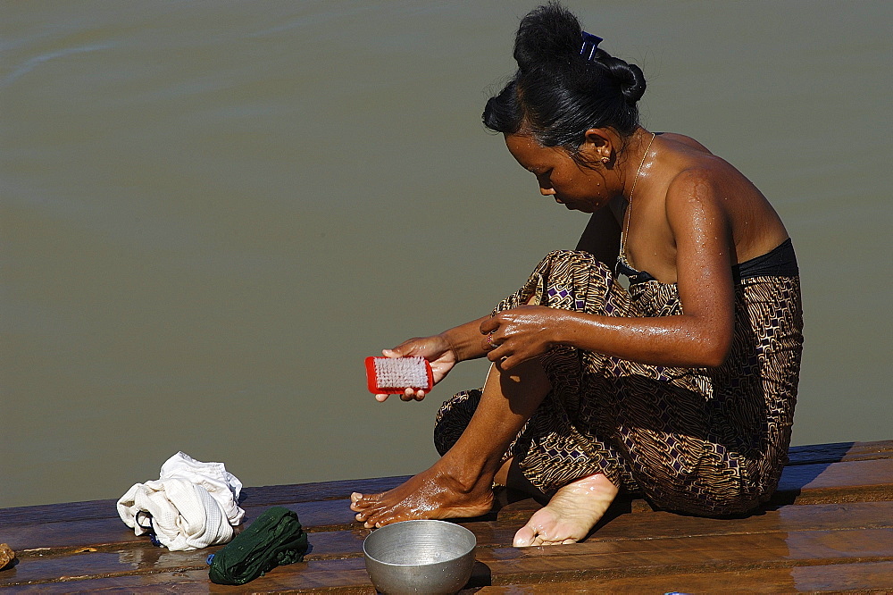 Woman washing, Indaign (Inthein), Inle Lake, Shan State, Myanmar (Burma), Asia