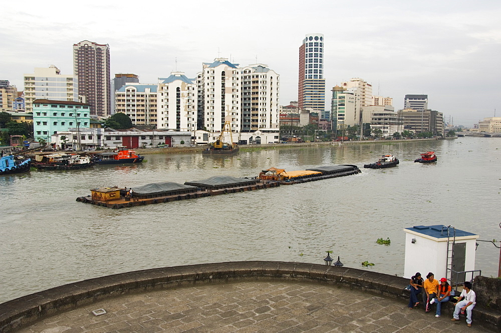 Barge on River Pasig with city skyline behind, Manila, Philippines, Southeast Asia, Asia