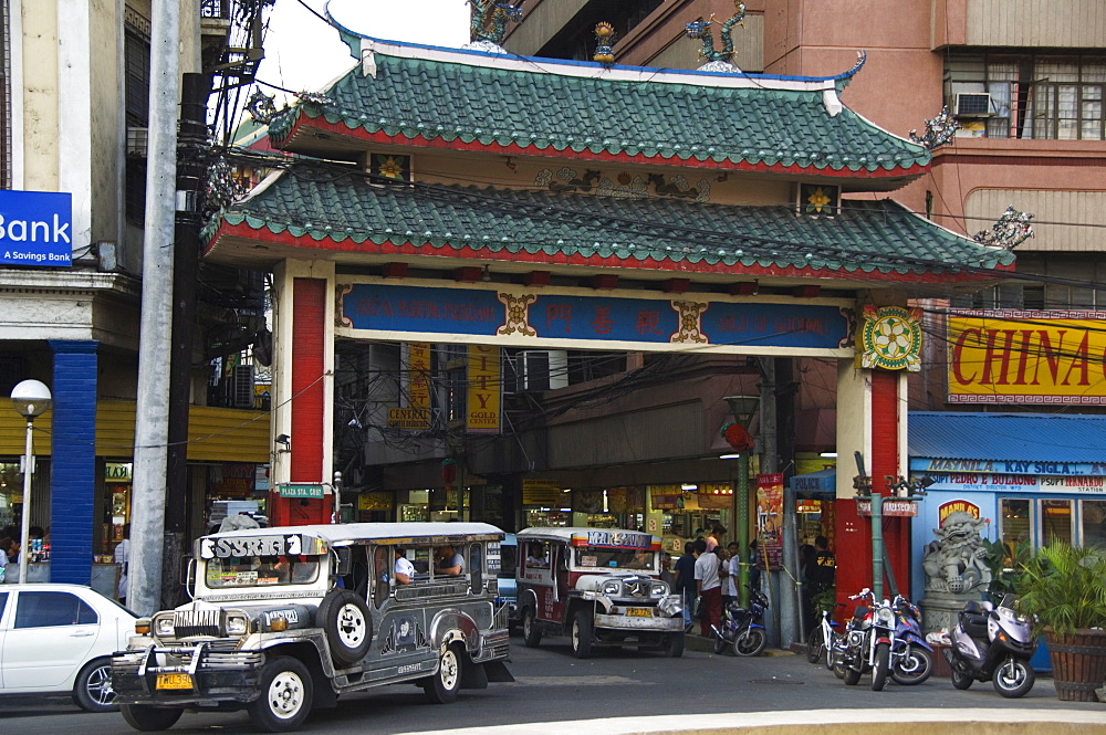 Jeepney driving under Chinatown Gate, Manila, Philippines, Southeast Asia, Asia