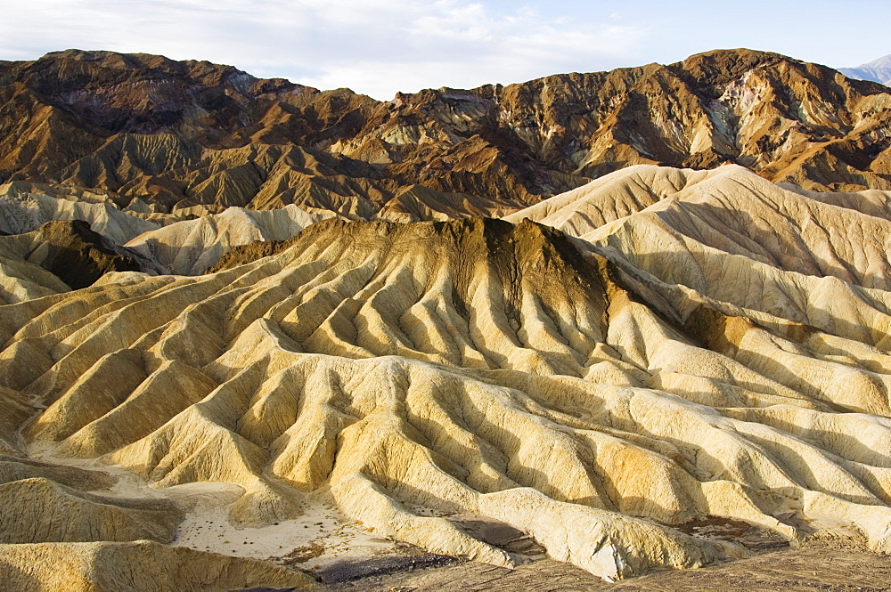 Early morning light on corrugated badlands landscape at Zabriskie Point, Death Valley National Park, California, United States of America, North America