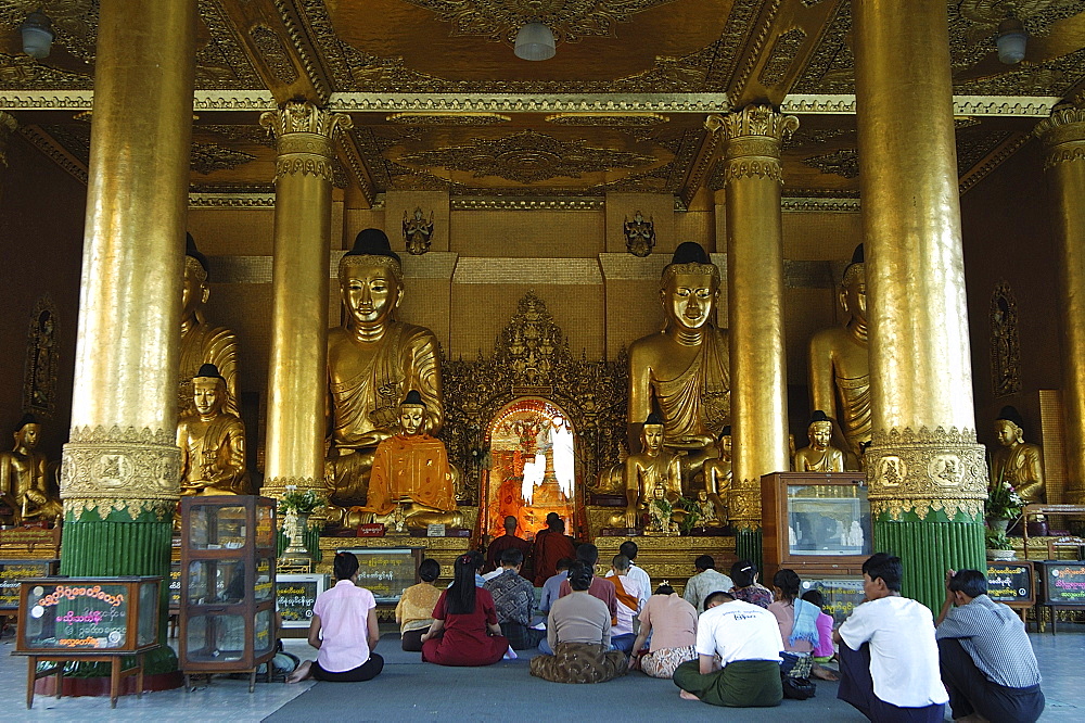 People praying at temple, Shwedagon Pagoda, Yangon (Rangoon), Myanmar (Burma), Asia