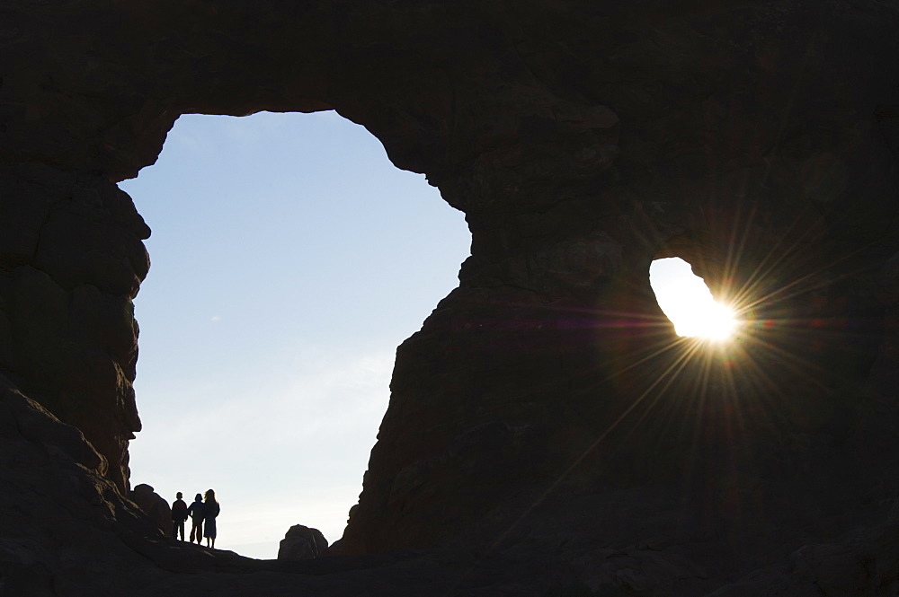 Children exploring South Arch in the Windows section of Arches National Park, Utah, United States of America, North America