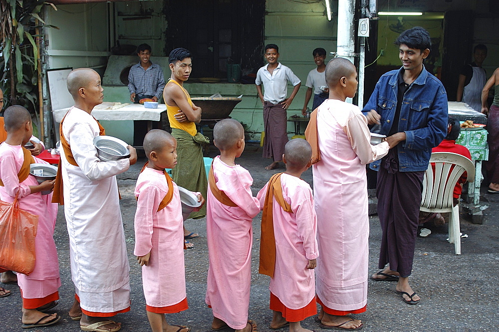 Nuns collecting morning alms, Yangon (Rangoon), Myanmar (Burma), Asia                     