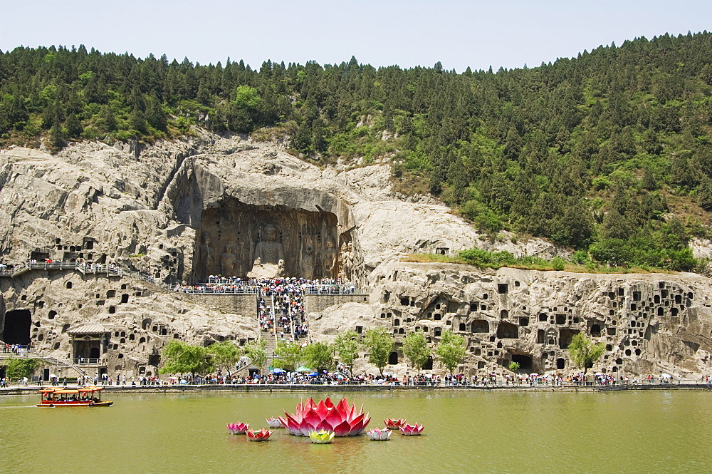 Carved Buddha images at Longmen Caves, Dragon Gate Grottoes, on the Yi He River dating from the 6th to 8th Centuries, UNESCO World Heritage Site, Henan Province, China, Asia