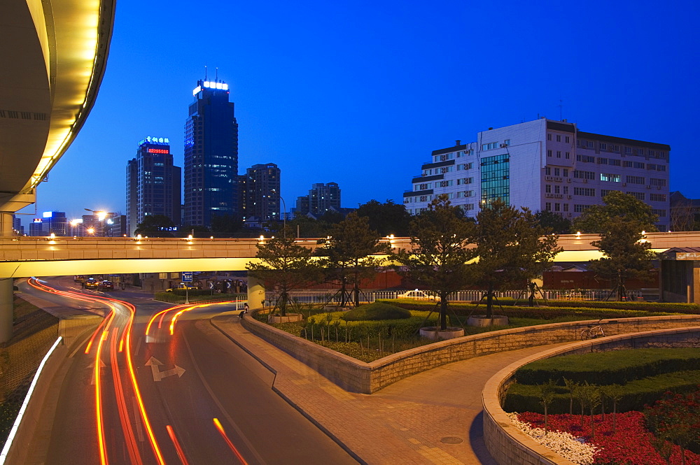 Car light trails and modern buildings near Beijing North Train Station, Xizhimen district, Beijing, China, Asia