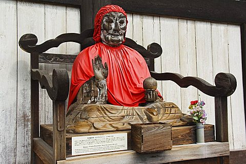 Jizo Buddha statue dressed in red cape, Todaiji (Big Buddha) Temple, constructed in the 8th century, Nara City Nara Prefecture, Honshu Island, Japan, Asia