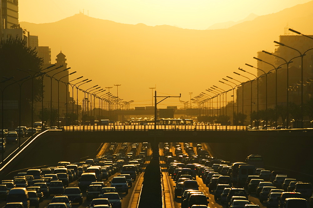 Sunset over city ring road during rush hour, Beijing, China, Asia