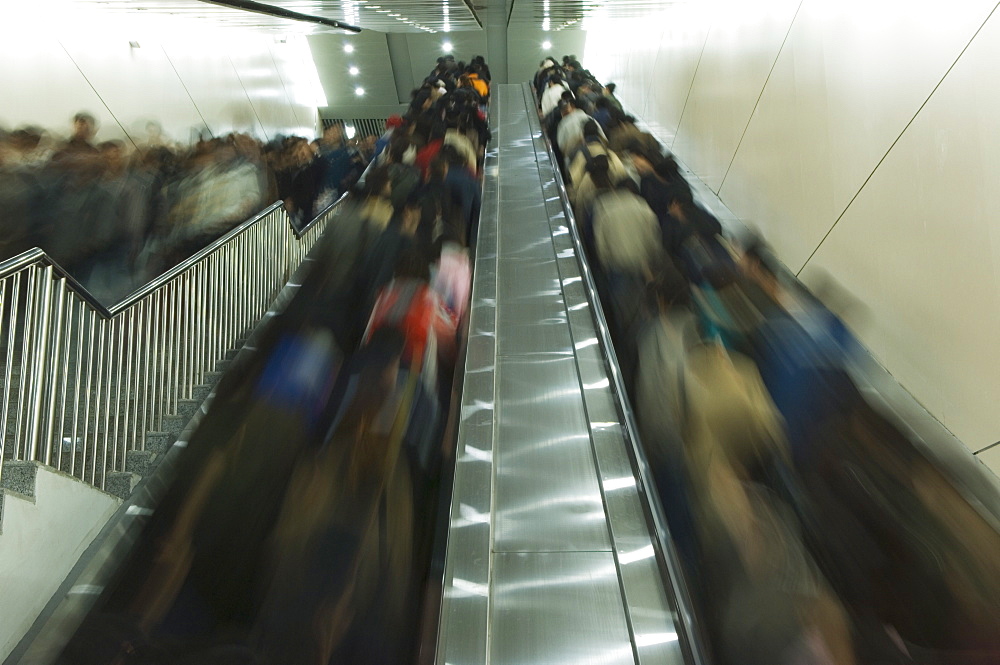 Passengers on moving on escalators on the Beijing subway, Beijing, China, Asia